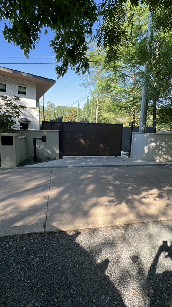 Modern wood composite sliding gate installation Austin TX