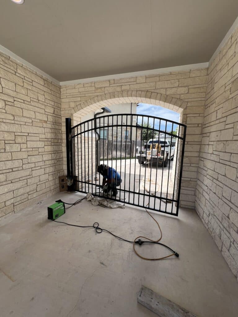 Custom arched wrought iron swing gate installation Austin TX
